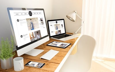 a laptop and a monitor in a home office