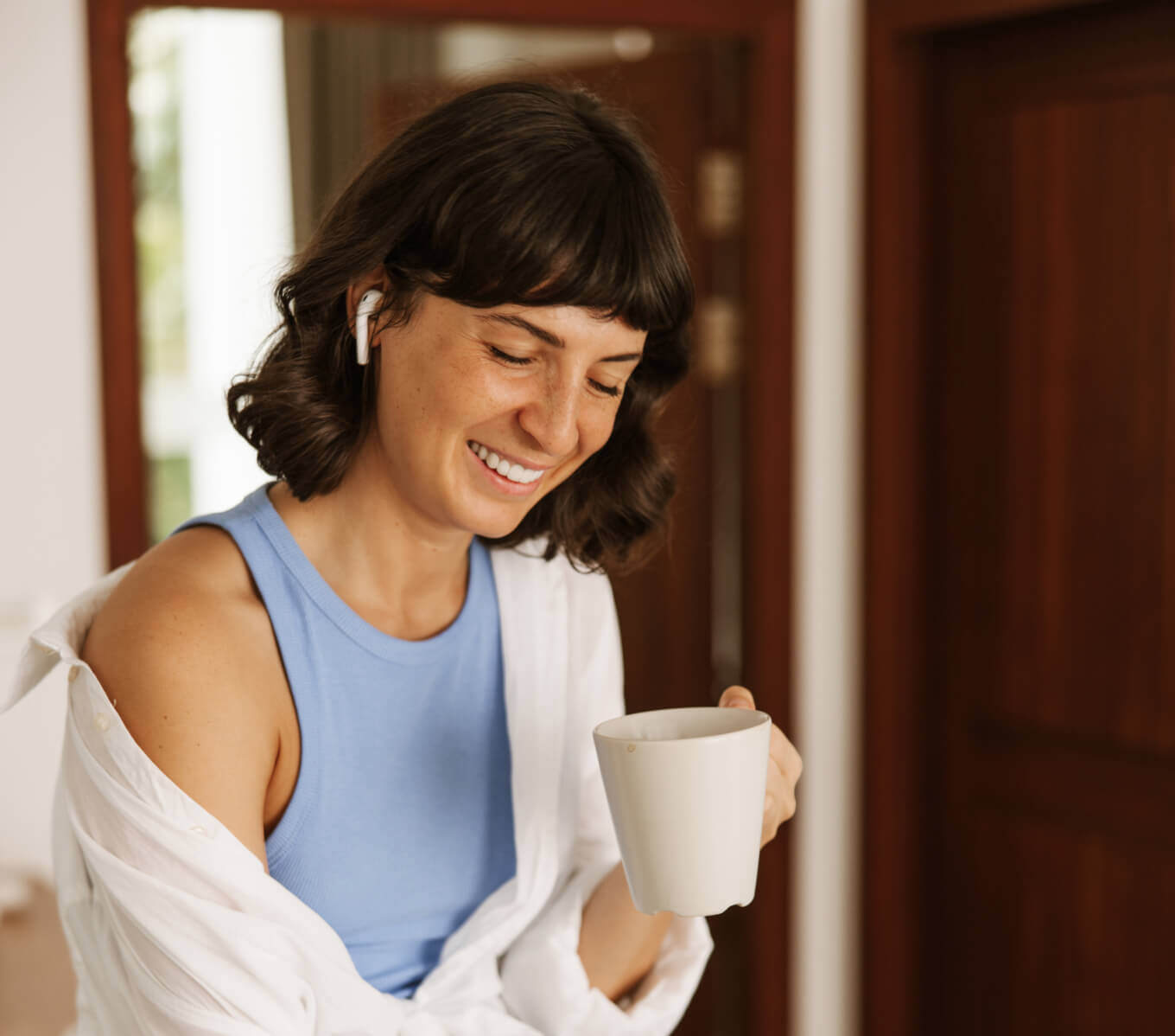 close-up-view-smiling-woman-holding-coffee-hand